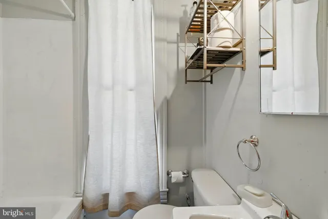a bathroom with a granite countertop shower and a sink