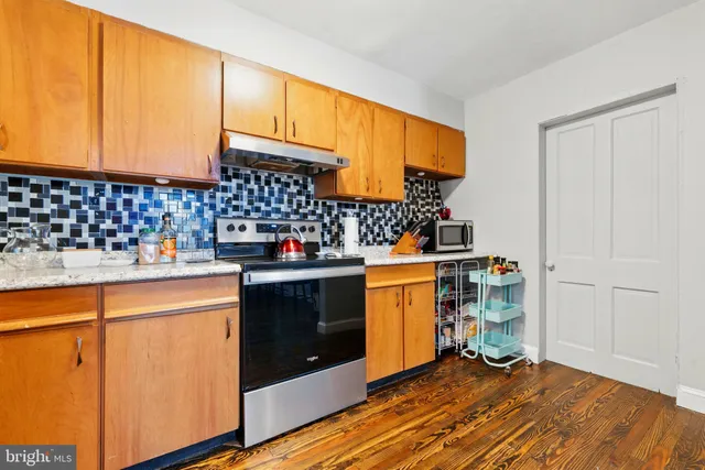 a kitchen with stainless steel appliances a sink and a refrigerator