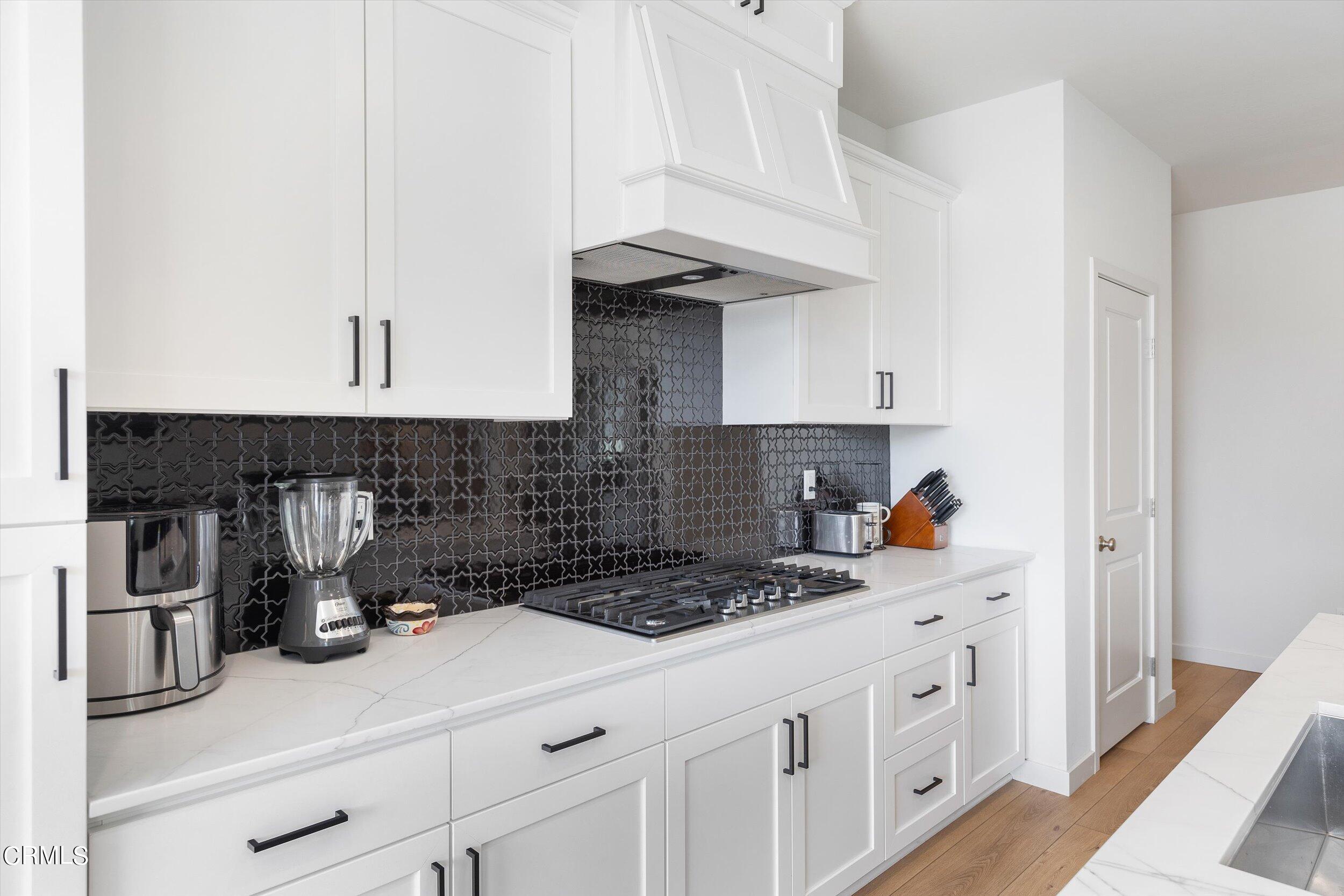 7405 Emerald Green Avenue Bakersfield, CA 93313 - Photo 15 of 39 a kitchen with appliances a cabinets and a counter space