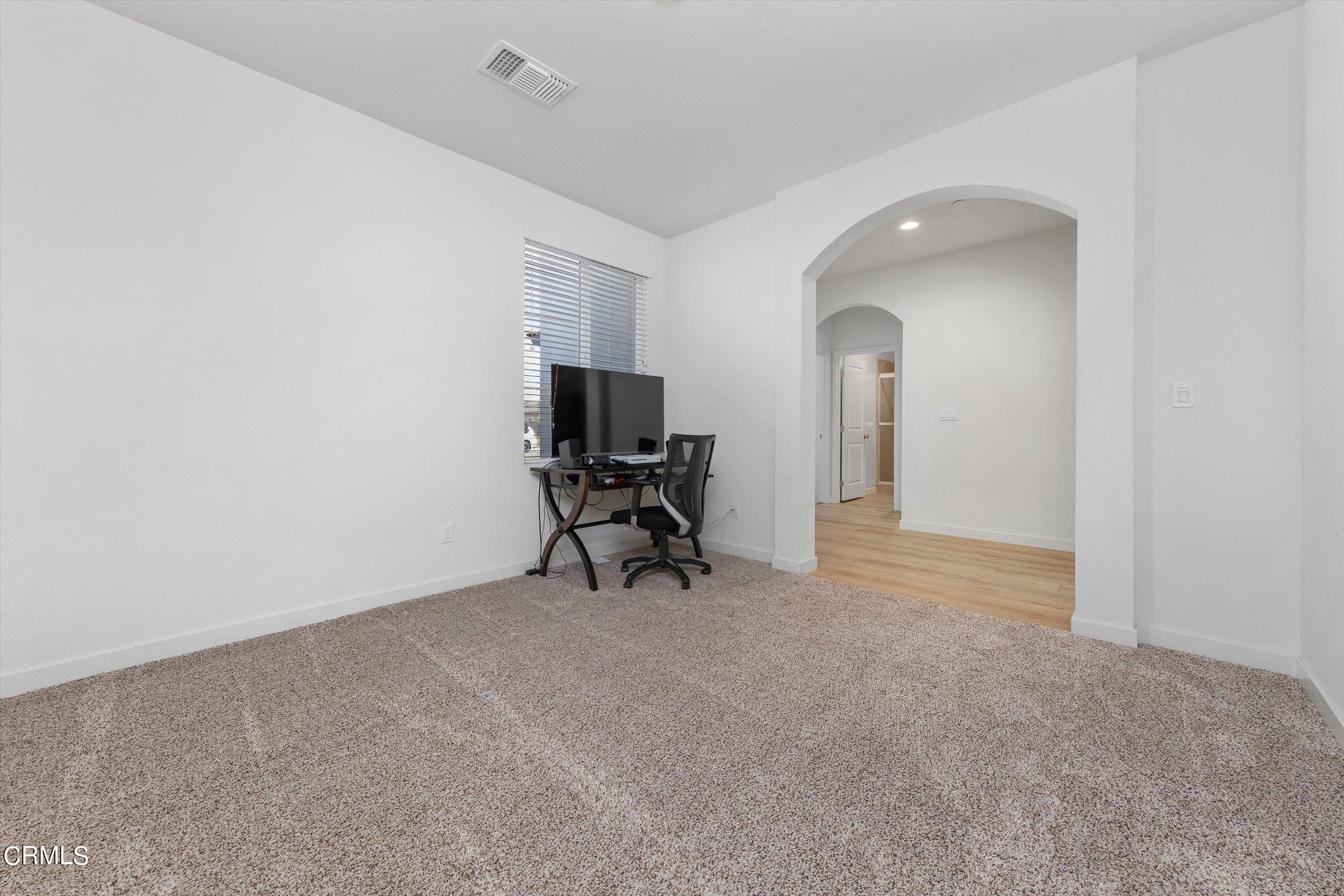 7405 Emerald Green Avenue Bakersfield, CA 93313 - Photo 18 of 39 a view of room with workspace and windows