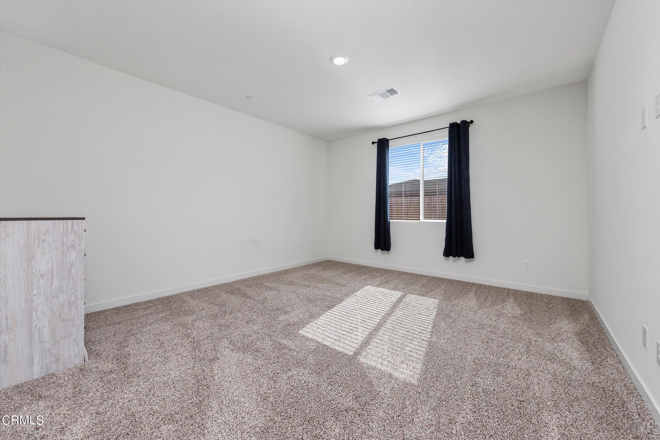 7405 Emerald Green Avenue Bakersfield, CA 93313 - Photo 20 of 39 a view of an empty room with a window