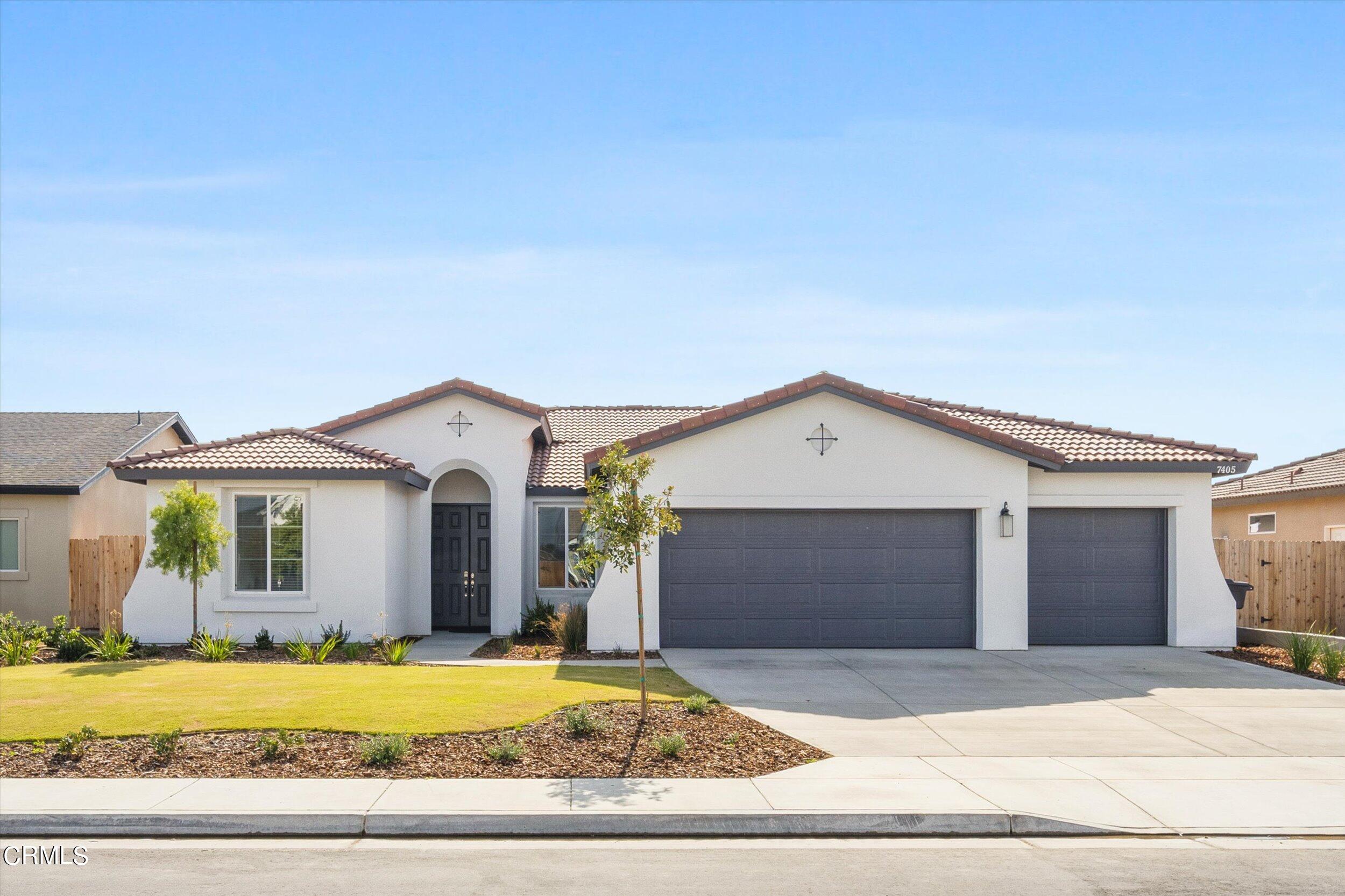 7405 Emerald Green Avenue Bakersfield, CA 93313 - Photo 2 of 39 a front view of a house with a garden