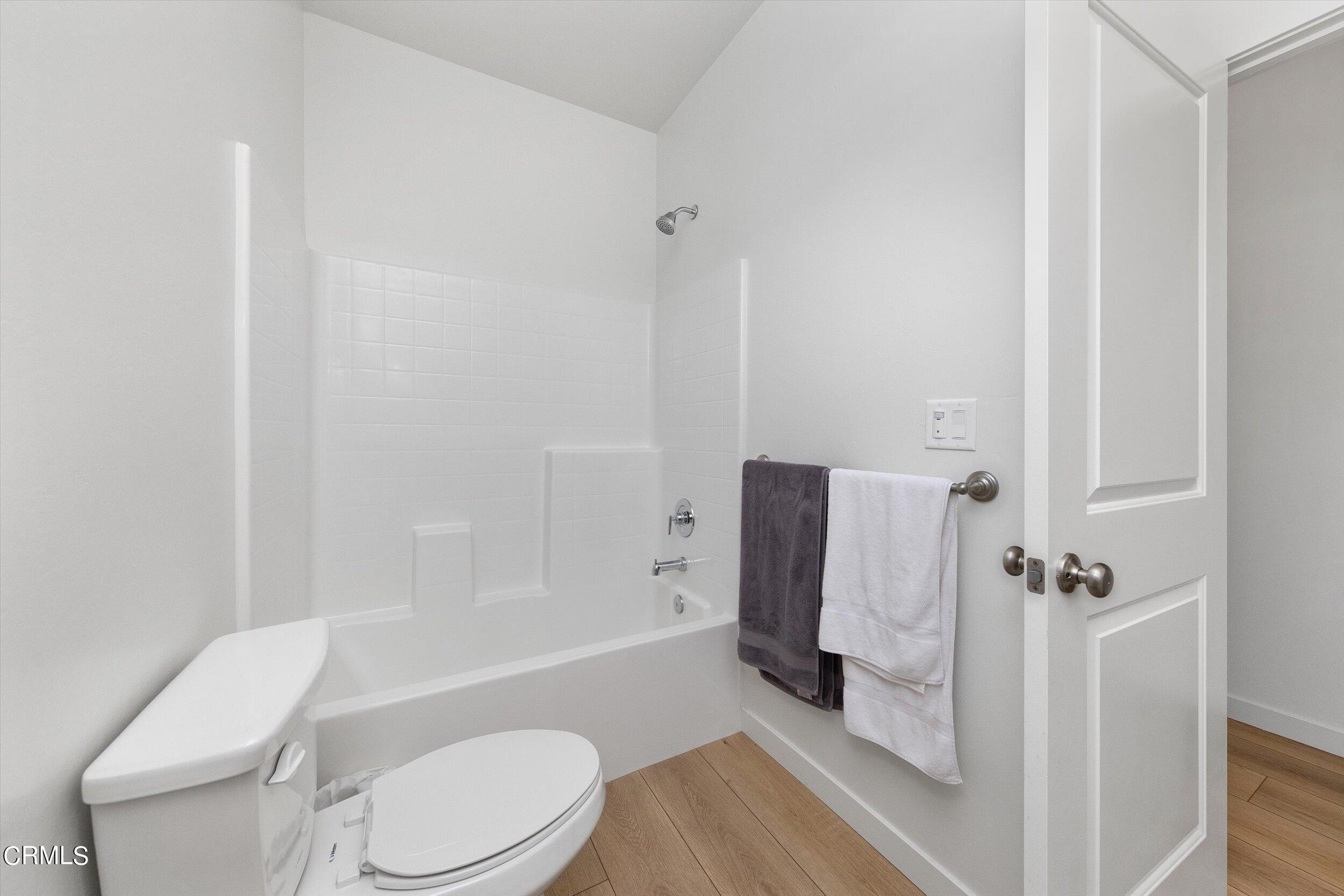 7405 Emerald Green Avenue Bakersfield, CA 93313 - Photo 28 of 39 a white toilet sitting next to a bathroom sink