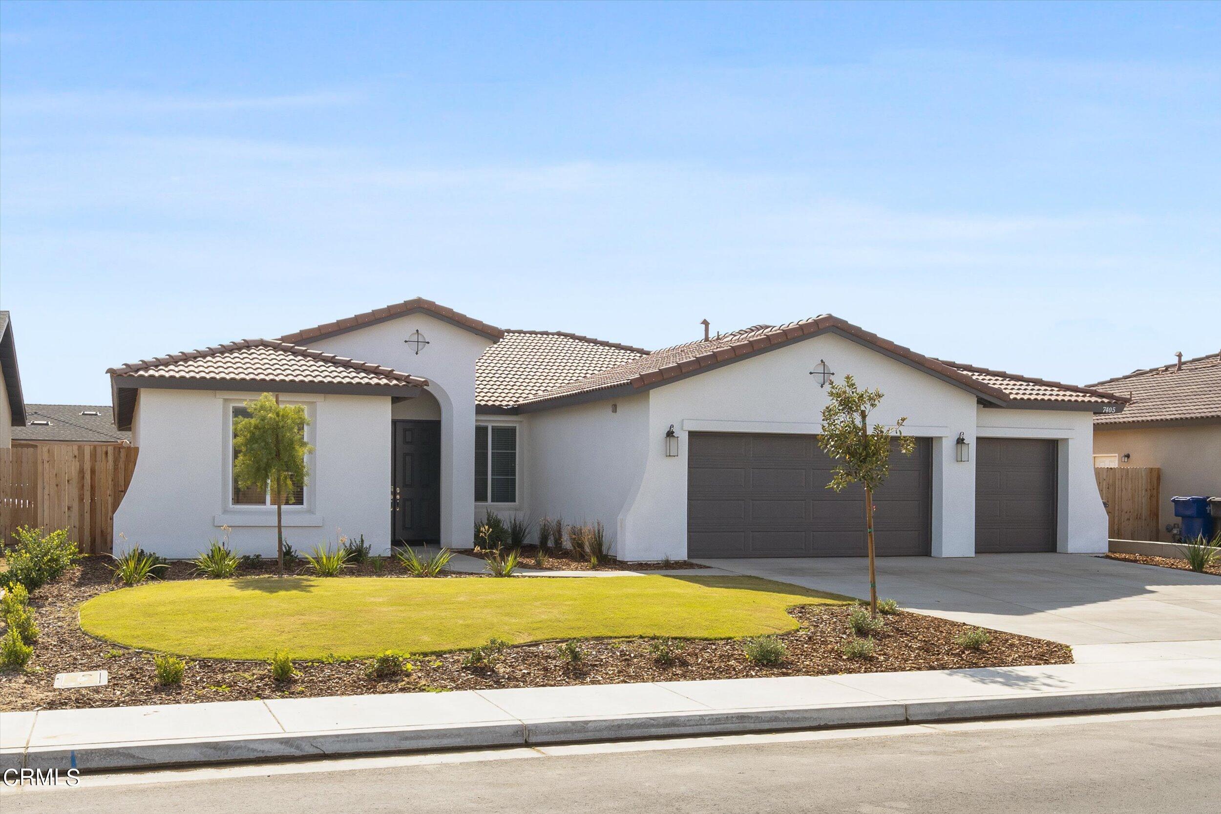 7405 Emerald Green Avenue Bakersfield, CA 93313 - Photo 3 of 39 a view of a house with a yard and garage