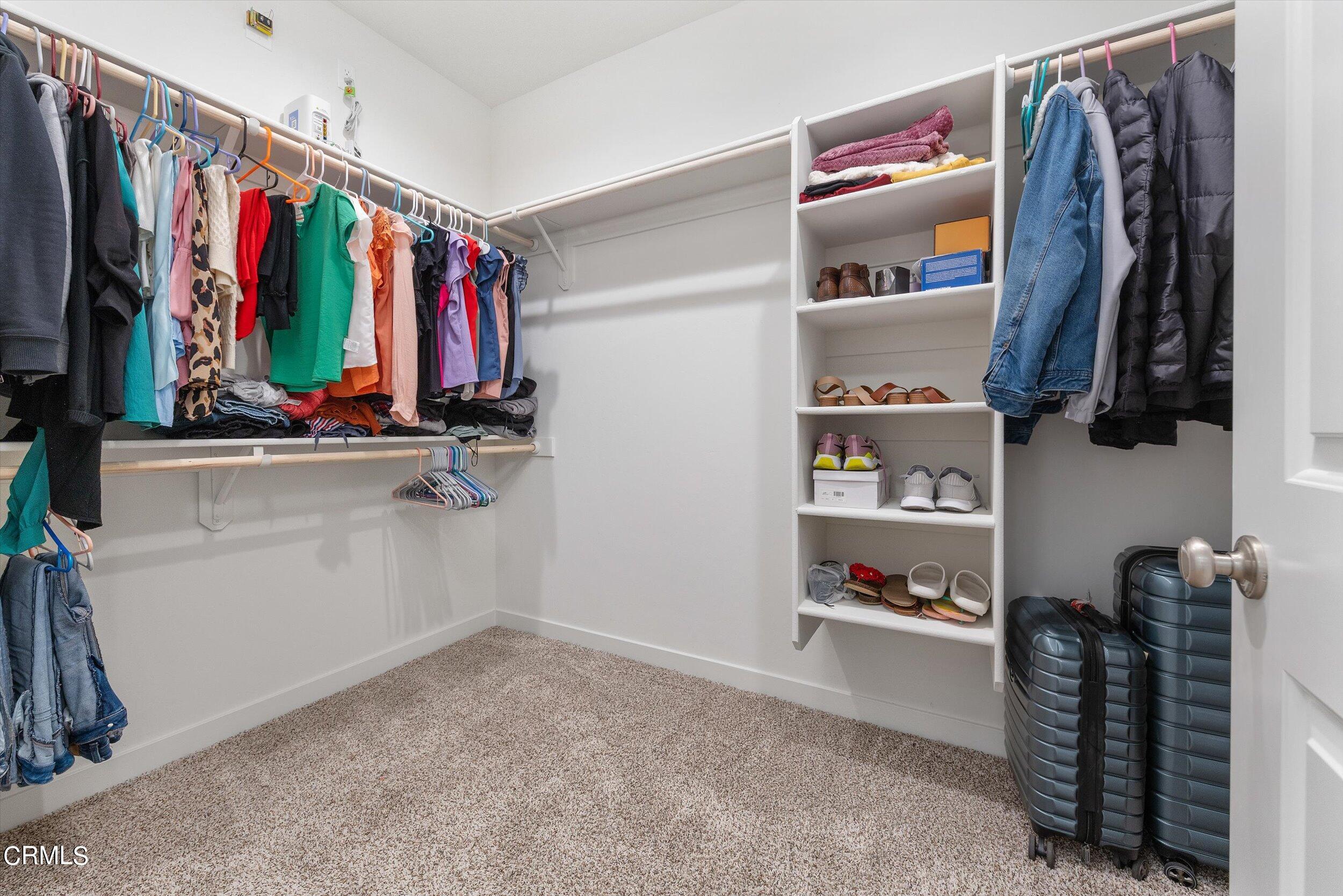 7405 Emerald Green Avenue Bakersfield, CA 93313 - Photo 31 of 39 a view of walk in closet with clothes and shoes
