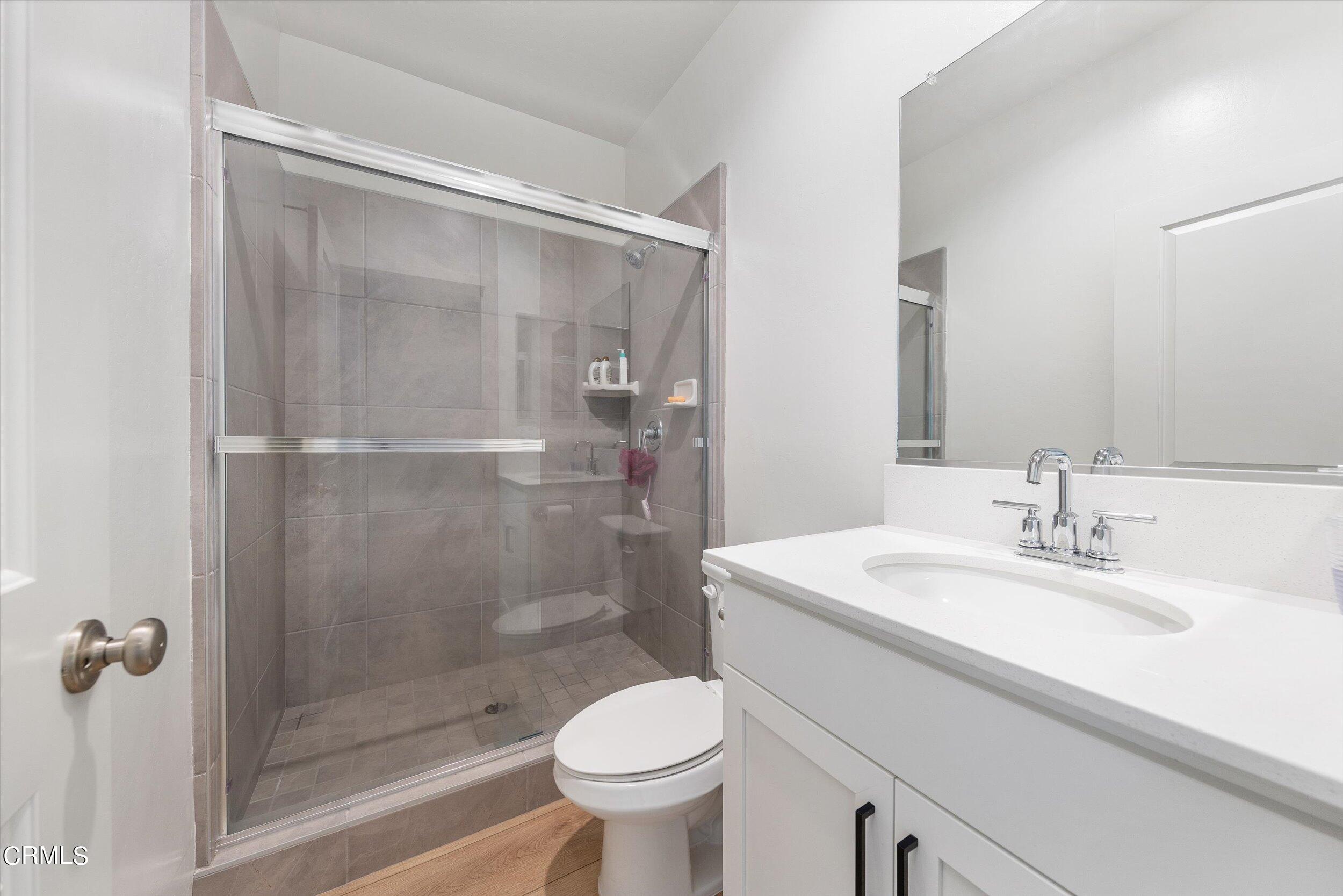 7405 Emerald Green Avenue Bakersfield, CA 93313 - Photo 33 of 39 a bathroom with a sink toilet and shower