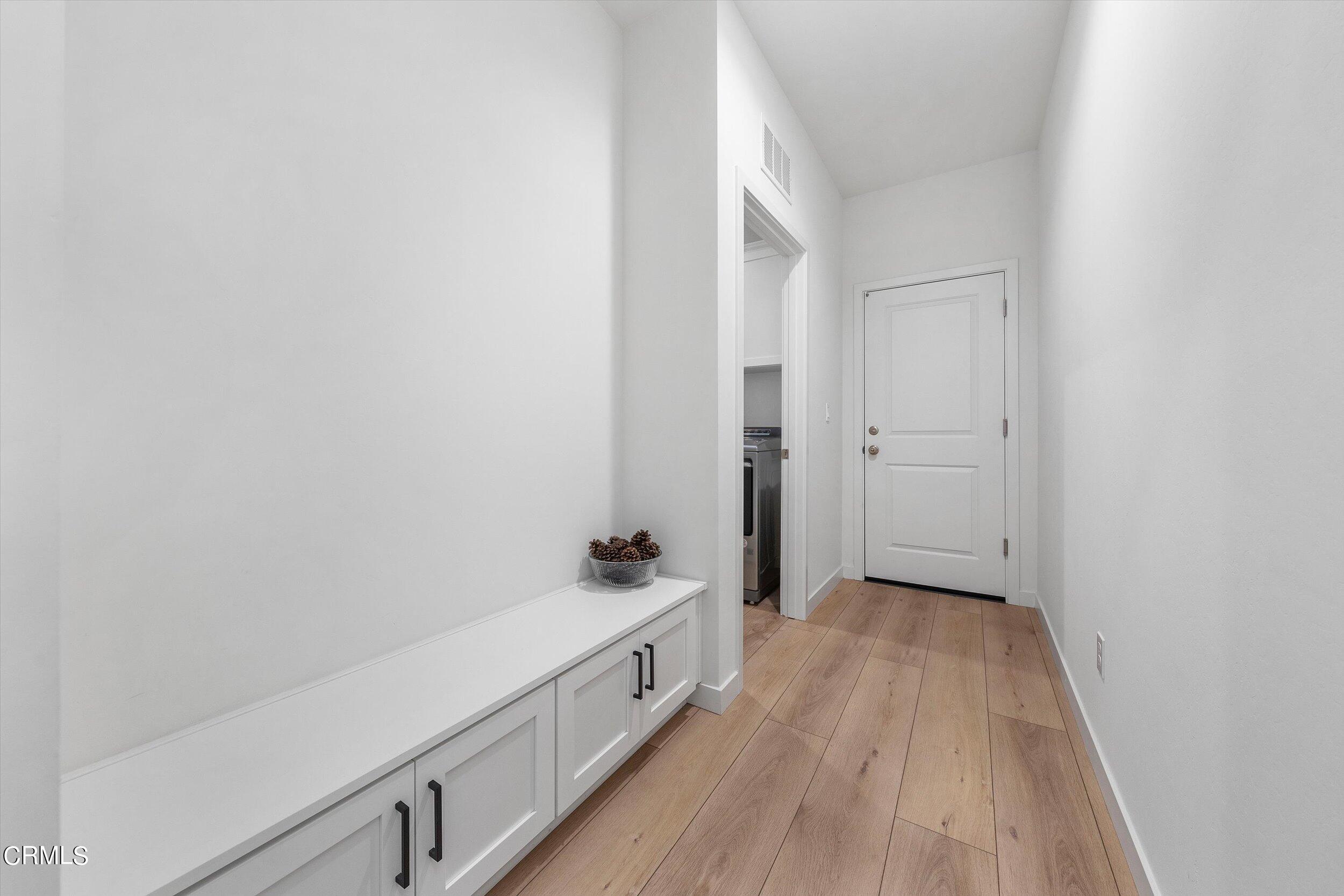 7405 Emerald Green Avenue Bakersfield, CA 93313 - Photo 34 of 39 a hallway with wooden floor