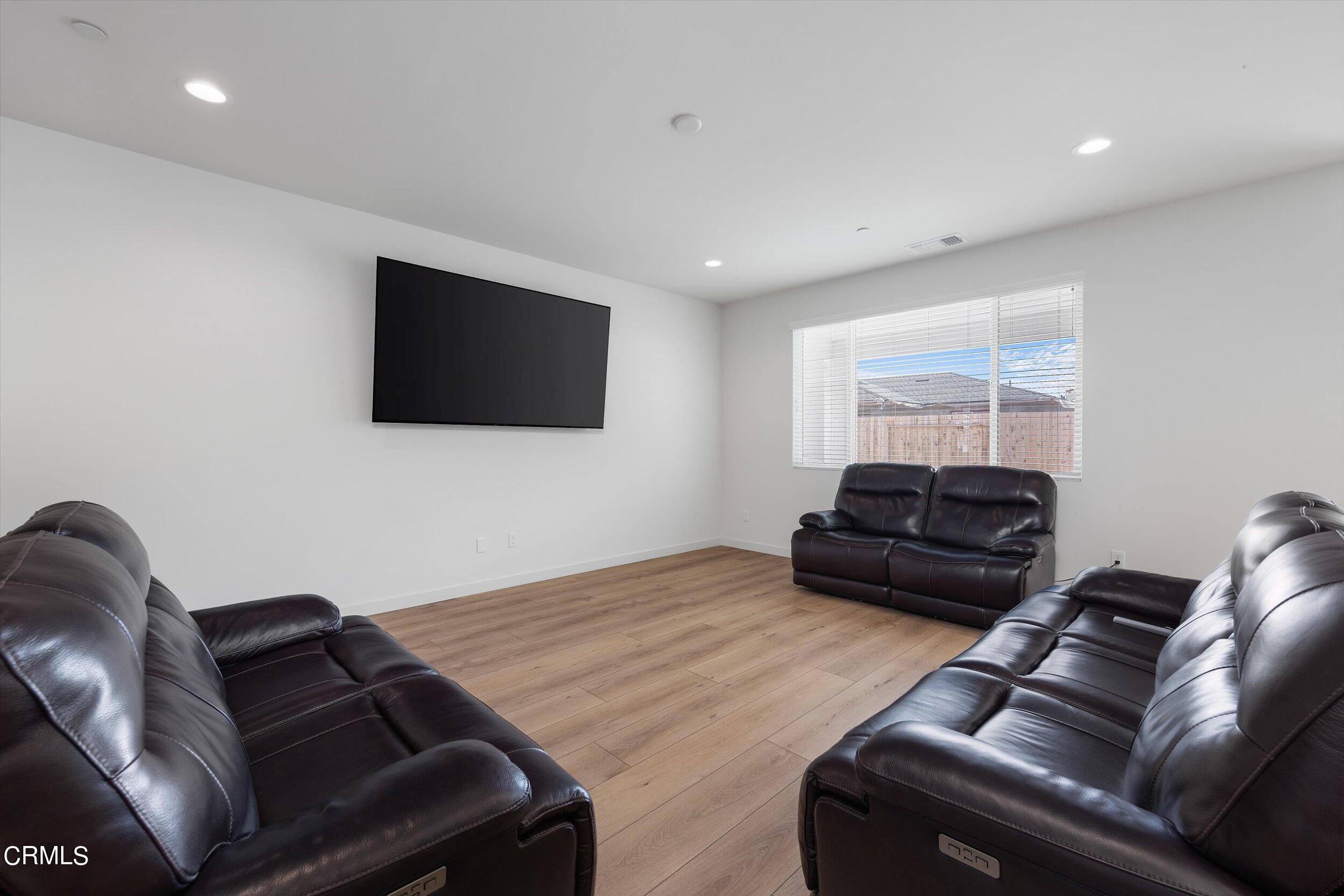 7405 Emerald Green Avenue Bakersfield, CA 93313 - Photo 5 of 39 a living room with furniture and a flat screen tv