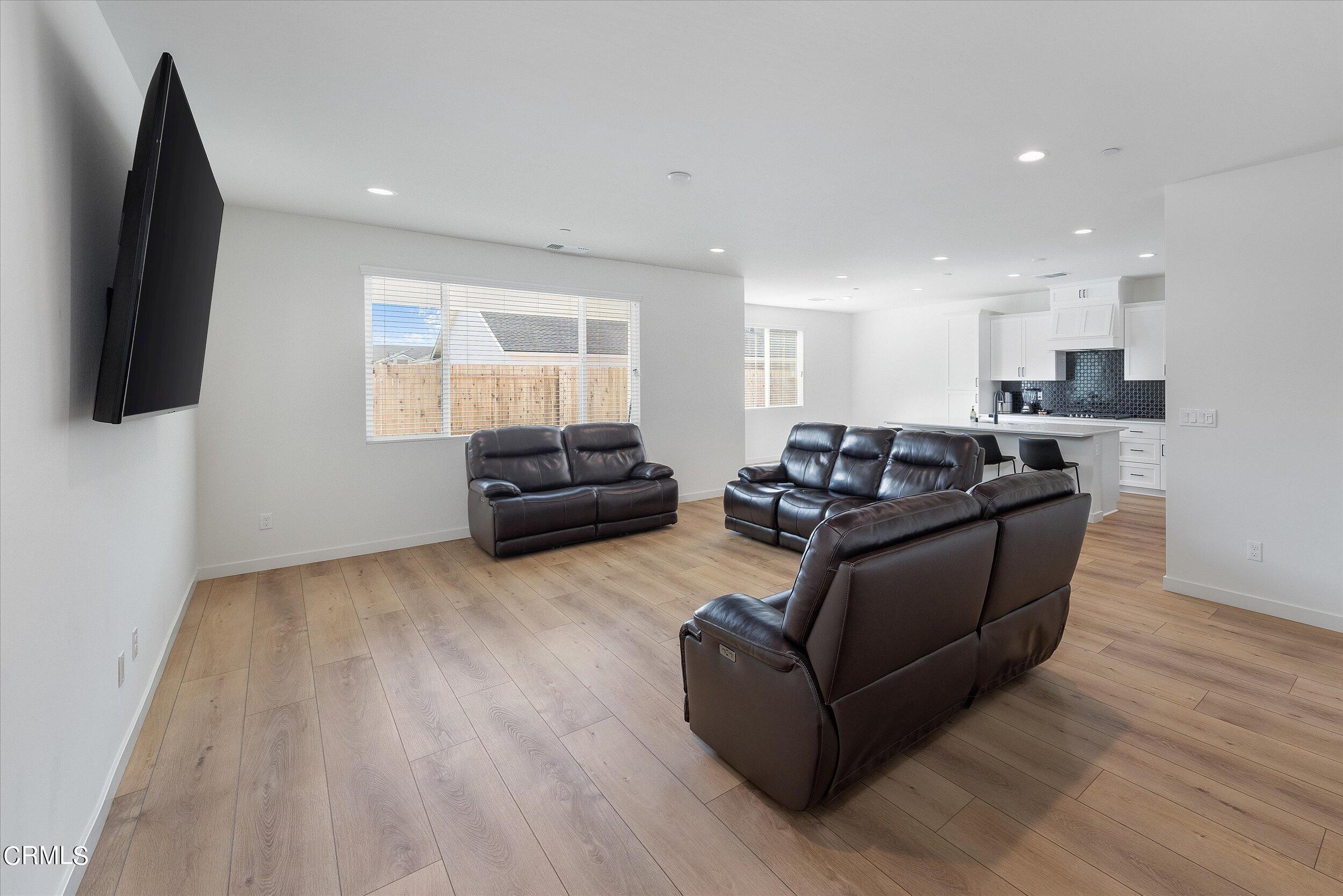 7405 Emerald Green Avenue Bakersfield, CA 93313 - Photo 7 of 39 a living room with furniture and a flat screen tv