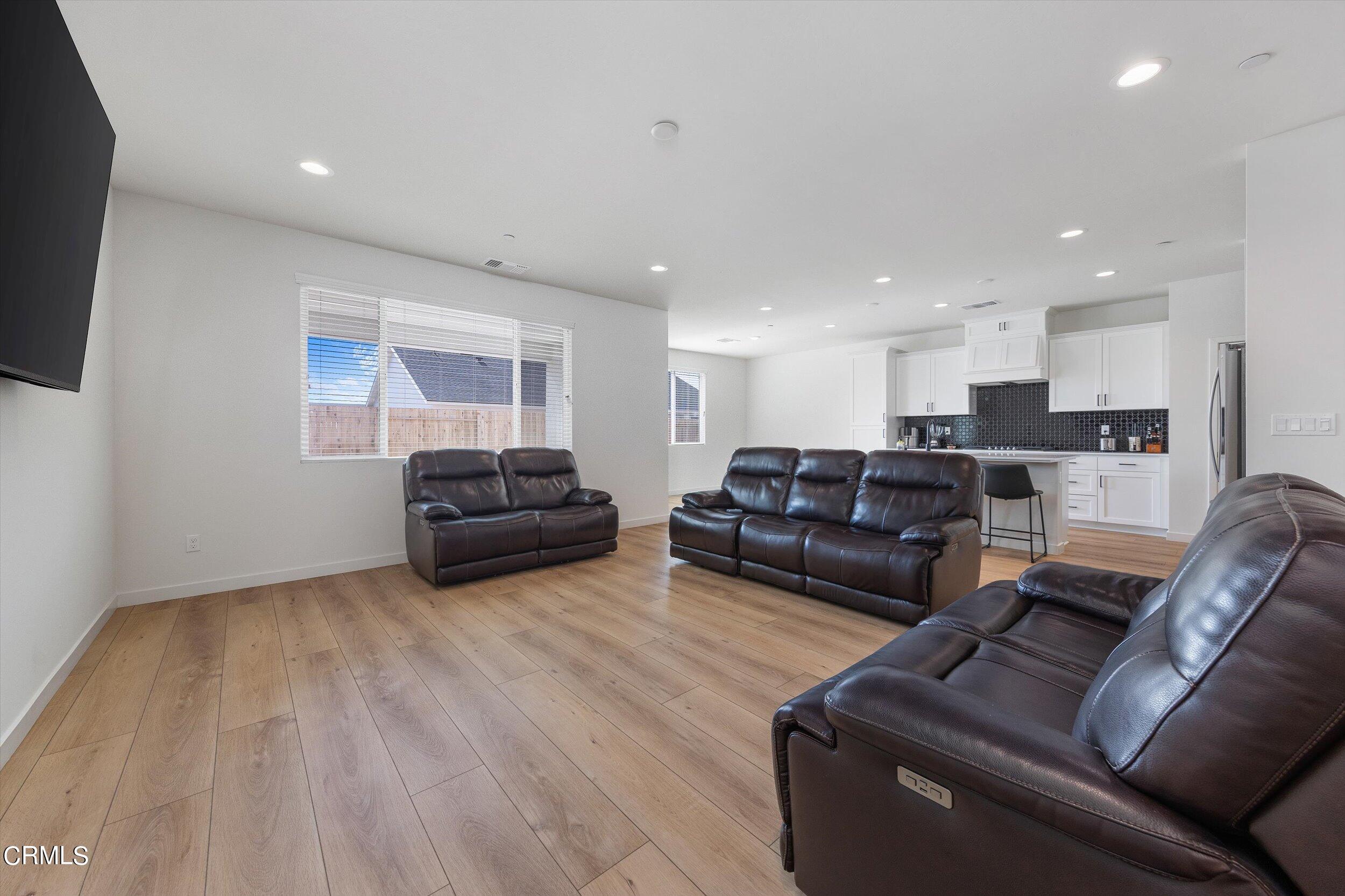 7405 Emerald Green Avenue Bakersfield, CA 93313 - Photo 8 of 39 a living room with furniture and a couch
