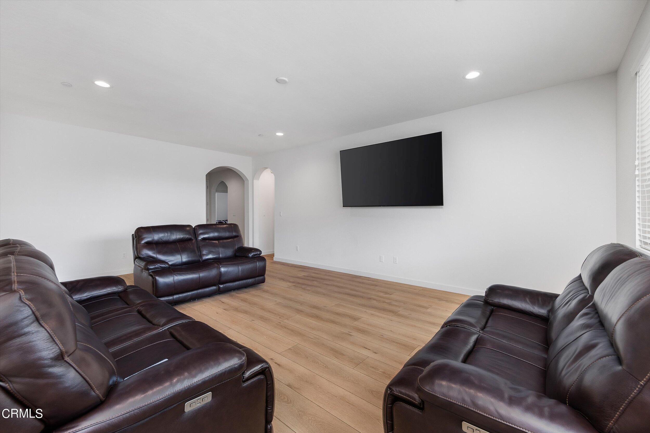 7405 Emerald Green Avenue Bakersfield, CA 93313 - Photo 10 of 39 a living room with furniture and a flat screen tv
