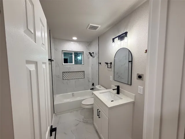 a kitchen with a sink a counter top space stainless steel appliances and a window