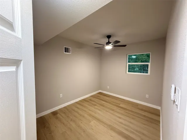 a view of a kitchen with a sink wooden cabinets and stainless steel appliances
