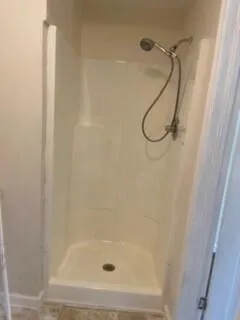 a bathroom with a glass shower door