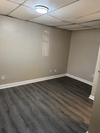 a view of an empty room with wooden floor
