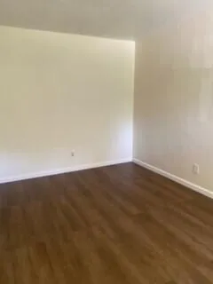 an empty room with wooden floor