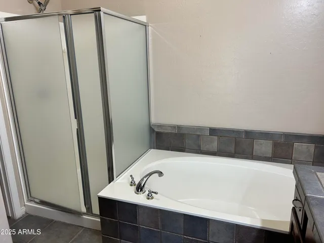 a bathroom with a bathtub and shower