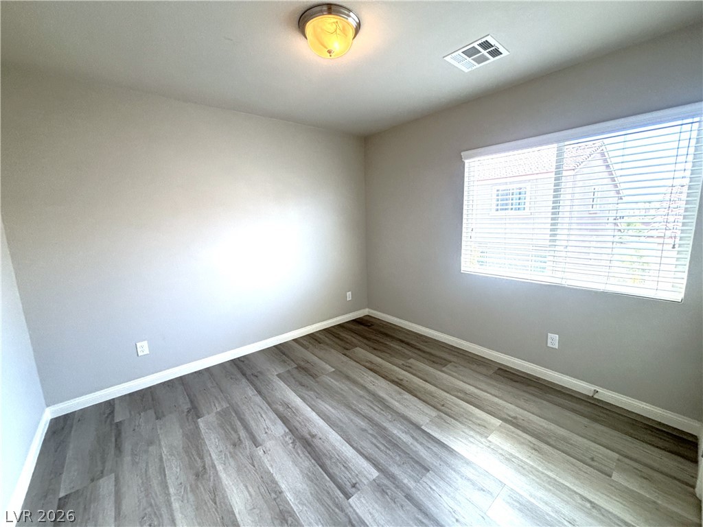 6425 Jackson Spring Road Las Vegas, NV 89118 - Photo 18 of 31 Durable plank flooring and ample window light define this versatile space.