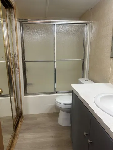 a bathroom with a toilet a sink and a shower