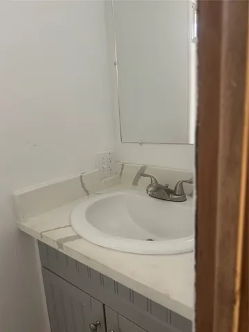a bathroom with a sink and vanity