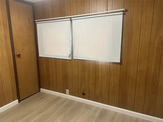 an empty room with wooden floor