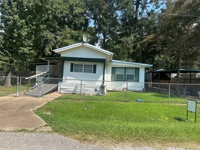 a front view of house with a garden