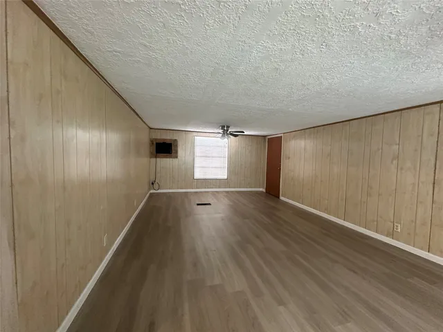 a view of hallway with wooden floor