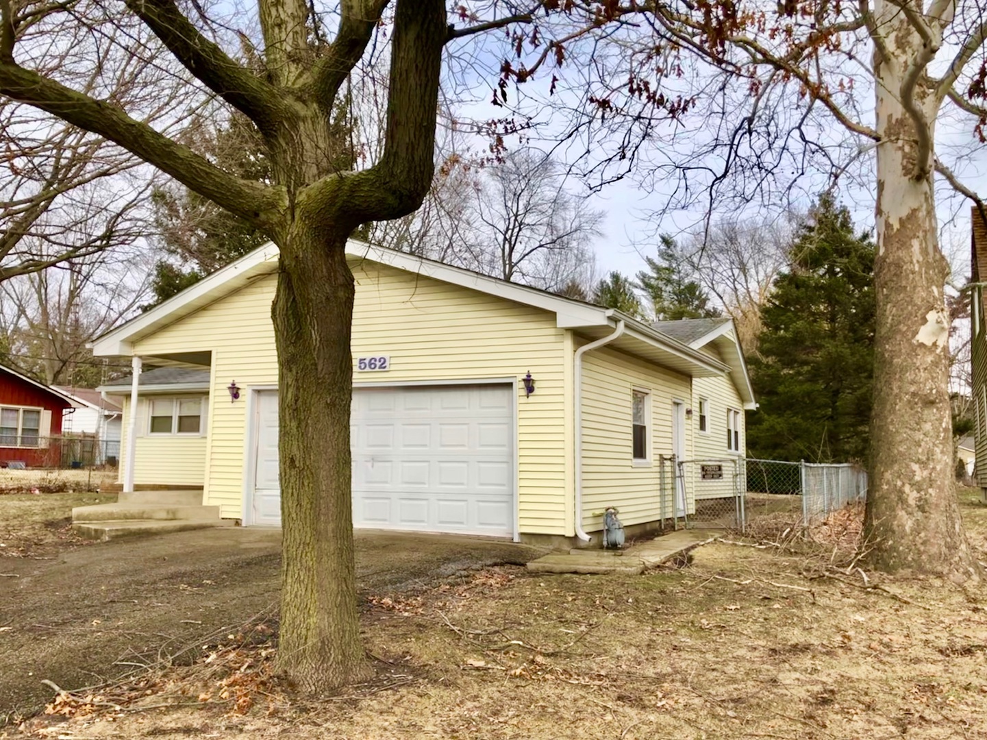 562 Russell Road DeKalb, IL 60115 - Photo 3 of 21 a house that has a tree in front of it