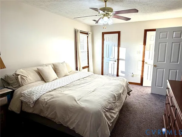 a large bed sitting in a bedroom next to a window