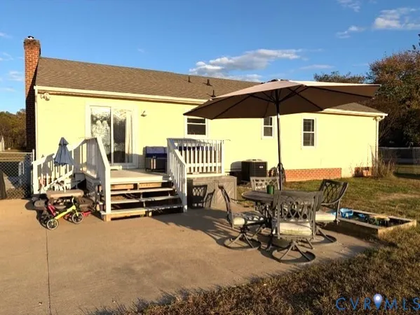 a view of a swimming pool with chairs in patio