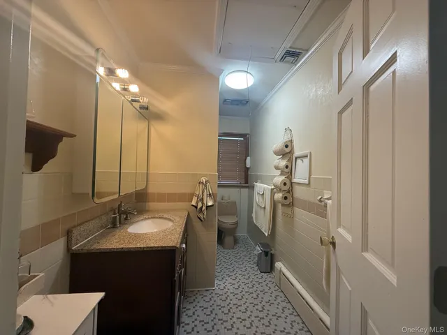 a white toilet sitting next to a bathroom sink