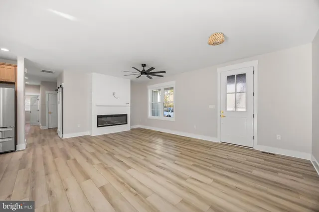 a view of an empty walk in closet with wooden floor