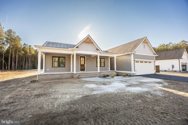 a view of a yard in front of a house with large trees