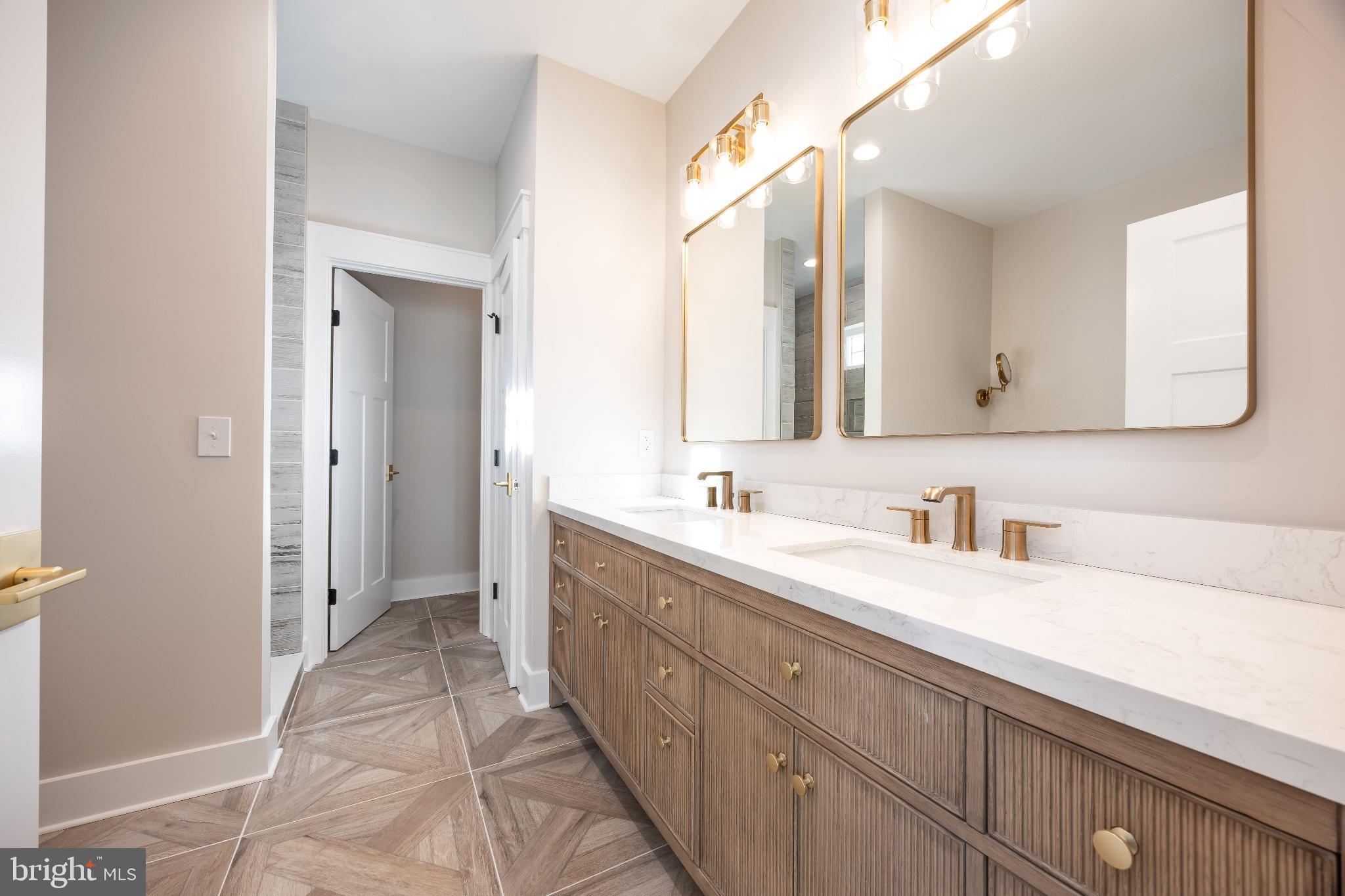 19438 Parsons Road Georgetown, DE 19947 - Photo 31 of 62 Elegant bathroom with dual vanities and mirrors.