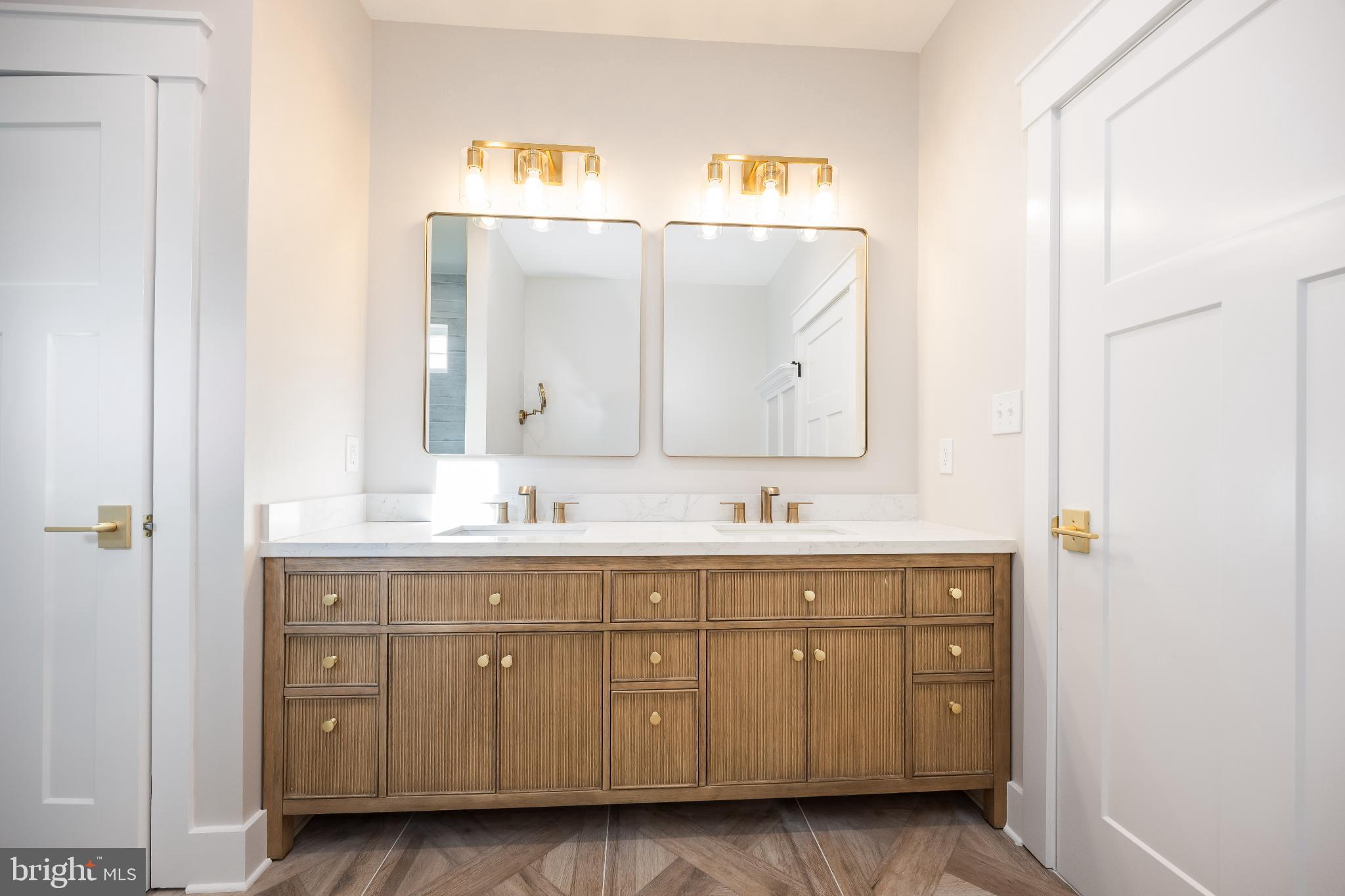 19438 Parsons Road Georgetown, DE 19947 - Photo 32 of 62 Elegant bathroom with dual mirrors and gold acc...