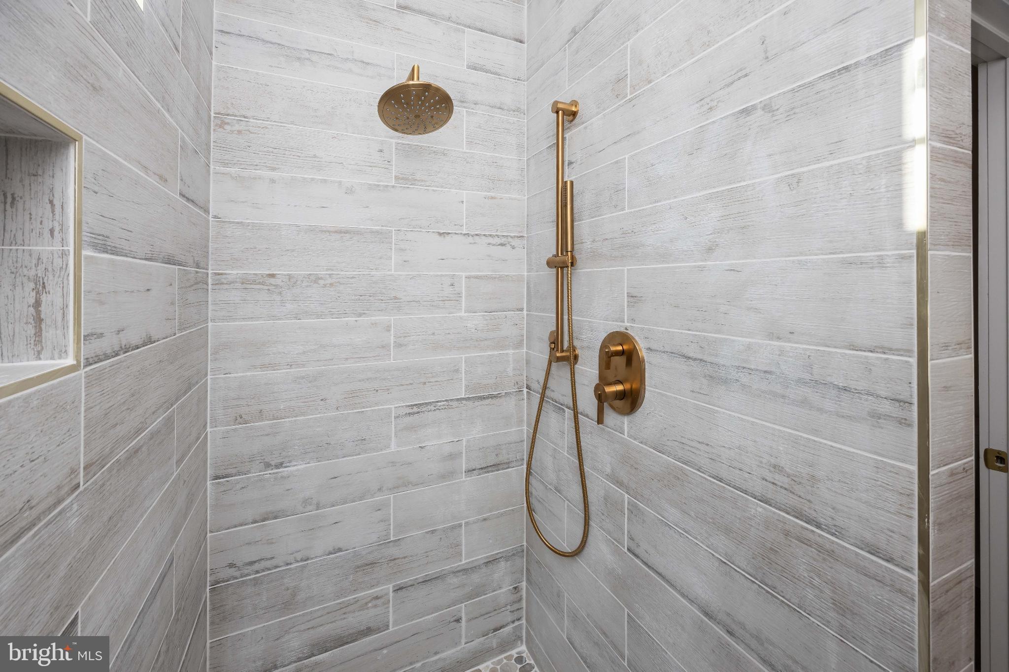 19438 Parsons Road Georgetown, DE 19947 - Photo 37 of 62 Sleek shower with elegant gold fixtures.