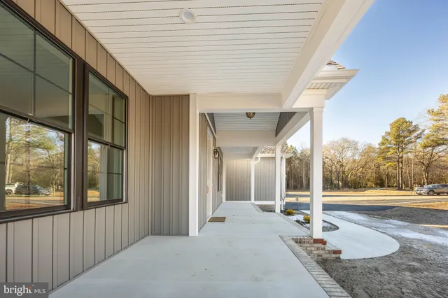 a large kitchen with stainless steel appliances kitchen island granite countertop a stove a refrigerator a oven and a sink with cabinets