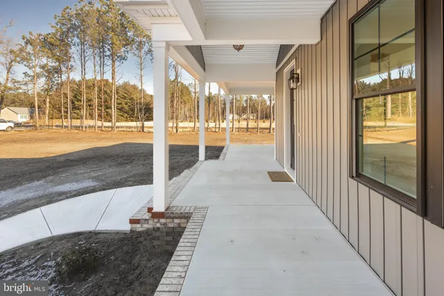 a kitchen with stainless steel appliances kitchen island granite countertop a refrigerator and a sink