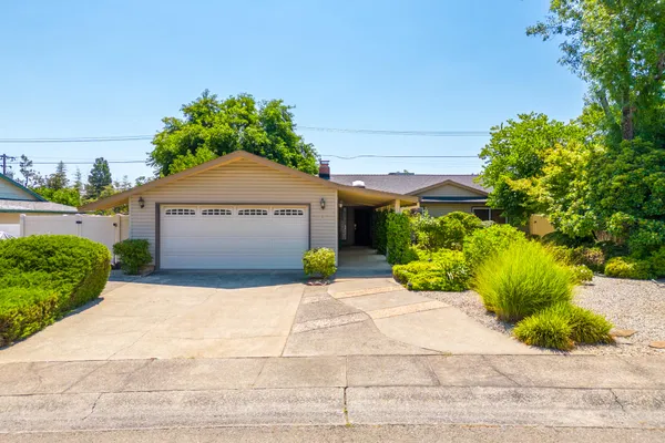 a front view of a house with a yard and a garage