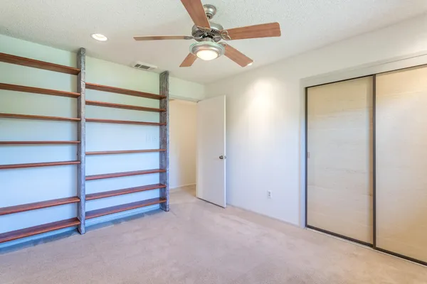 a view of room with a ceiling fan