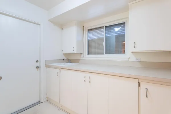 a view of kitchen with granite countertop cabinets