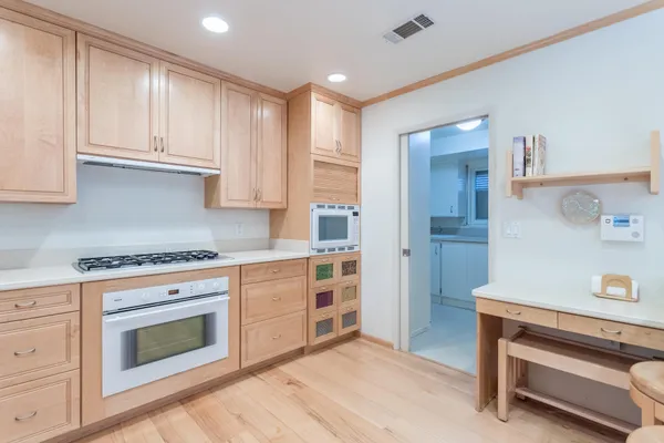 a kitchen with stainless steel appliances granite countertop a stove and a refrigerator