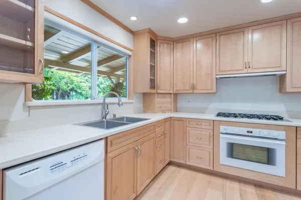 a kitchen with a sink stove and cabinets
