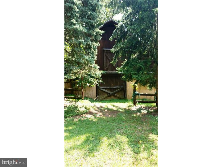 9 Stone Hill Road Allentown, NJ 08501 - Photo 20 of 24 a backyard of a house with a large tree
