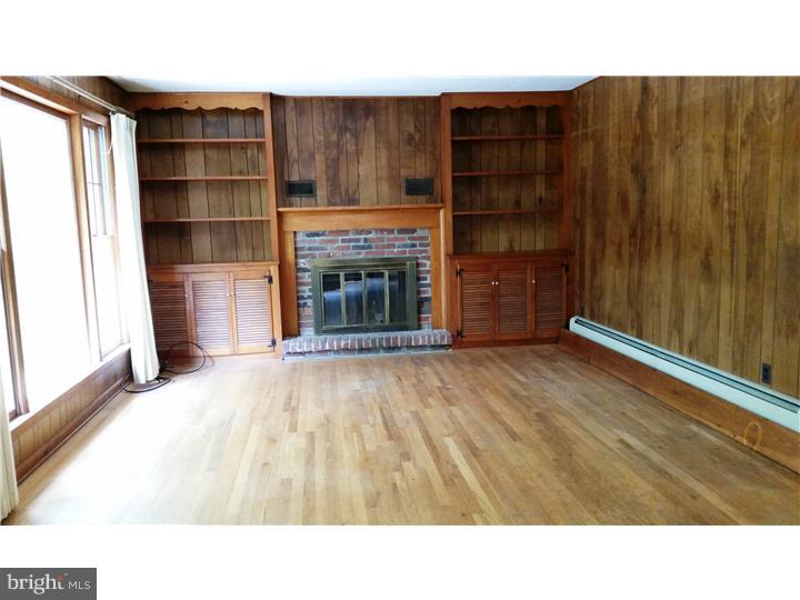 9 Stone Hill Road Allentown, NJ 08501 - Photo 8 of 24 a living room with a fireplace and cabinets