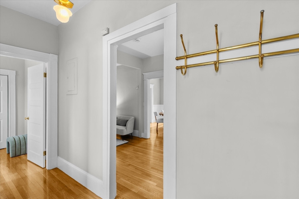 9 Verndale Street, Unit 2 Brookline, MA 02446 - Photo 24 of 39 a view of a hallway with wooden floor and staircase