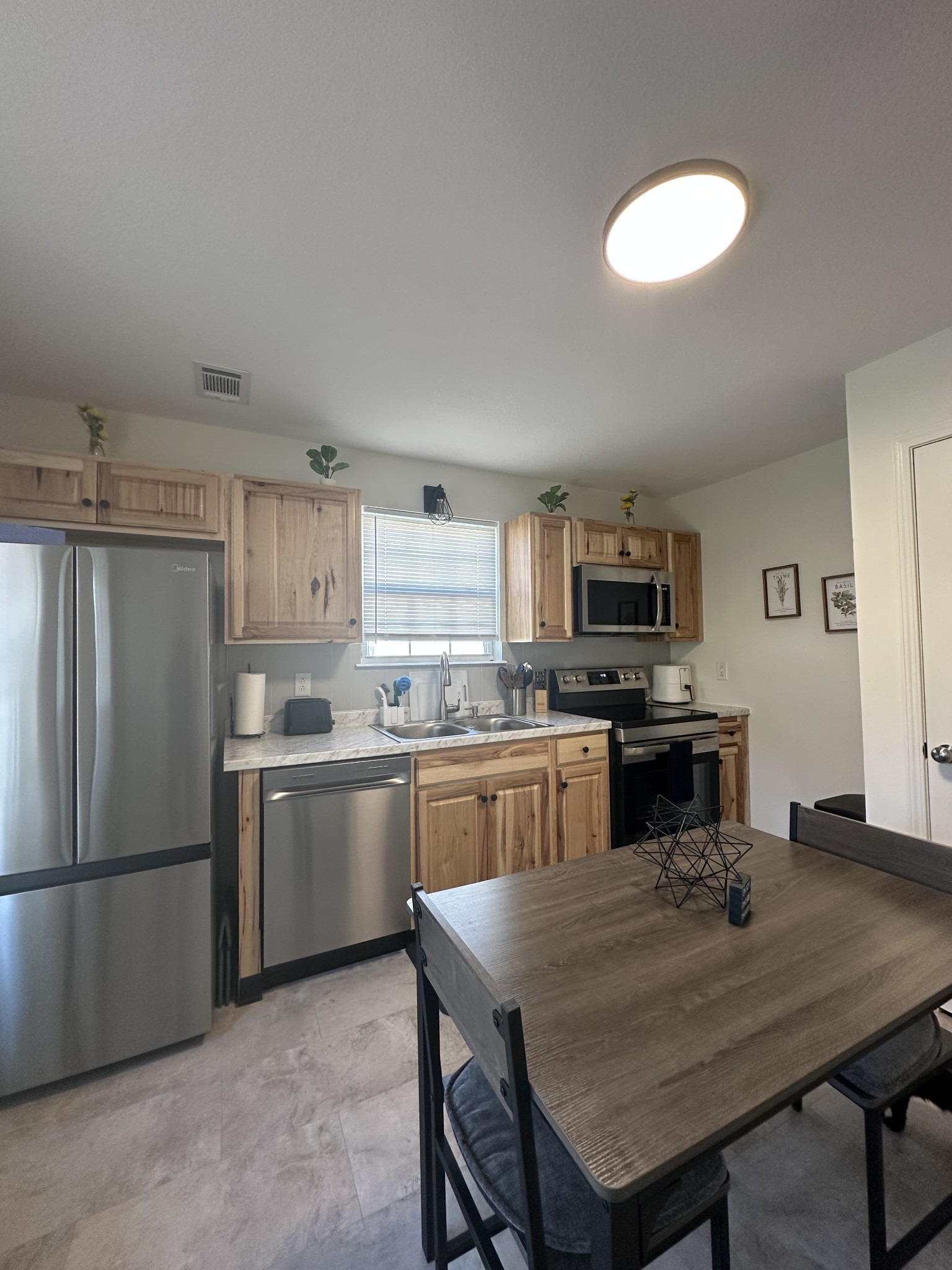 1027 Shadow Ridge Avenue Oak Grove, KY 42262 - Photo 5 of 14 a kitchen with stainless steel appliances granite countertop a refrigerator a sink dishwasher a stove with wooden cabinets and floor