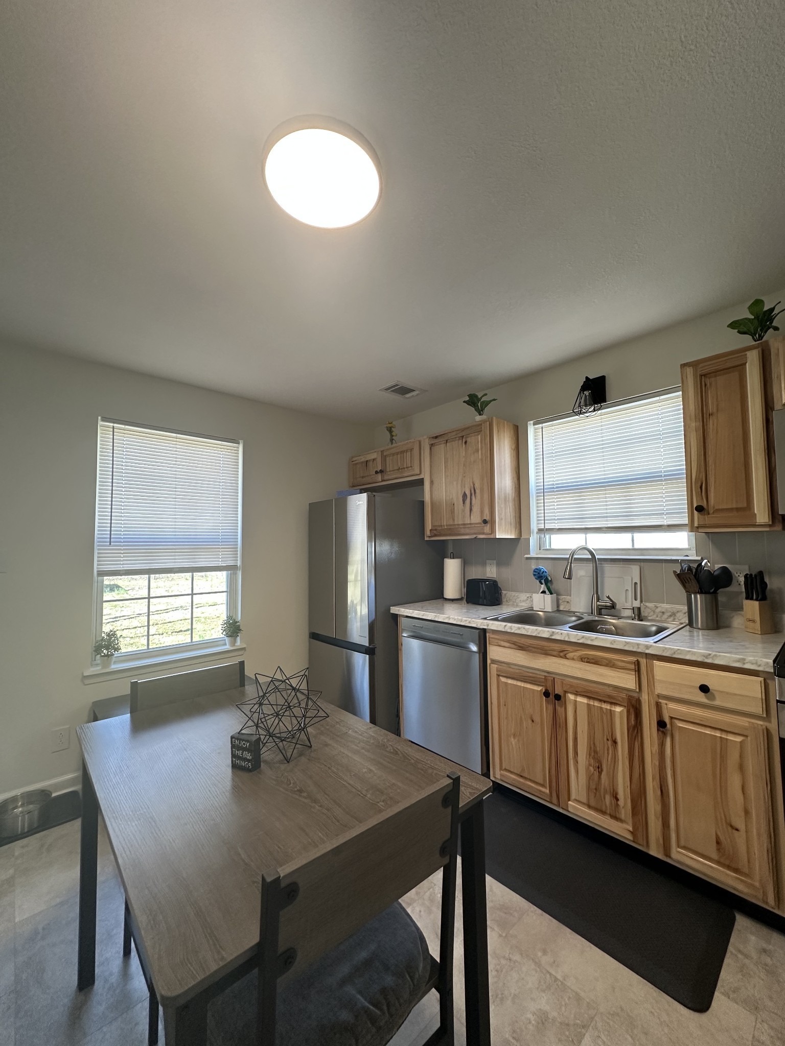 1027 Shadow Ridge Avenue Oak Grove, KY 42262 - Photo 6 of 14 a kitchen with a table chairs sink and cabinets