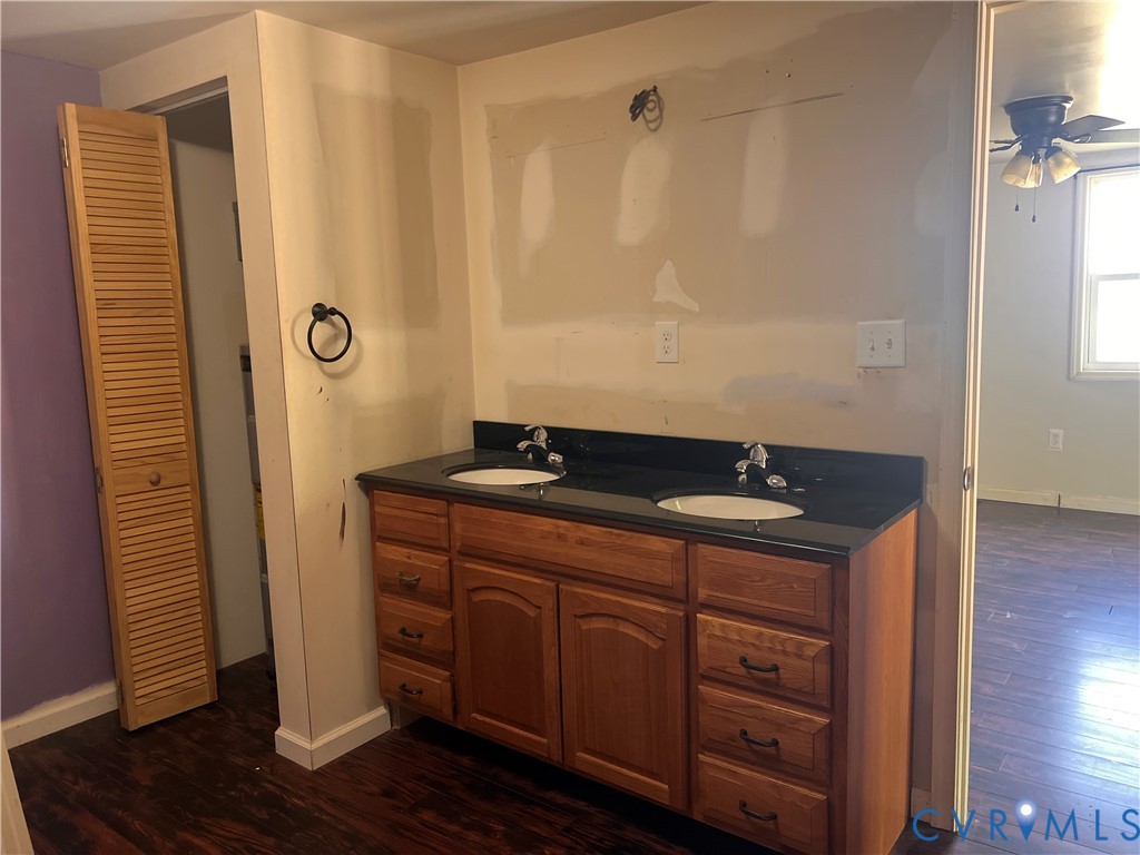 36210 Owens Grove Road Waverly, VA 23890 - Photo 14 of 24 a bathroom with a granite countertop sink and a mirror