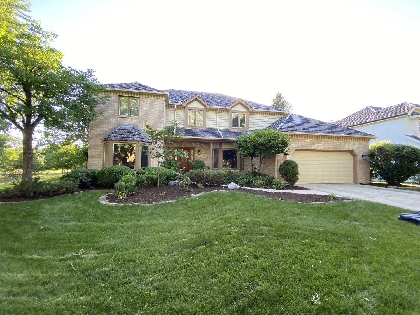 a front view of a house with a yard and garage